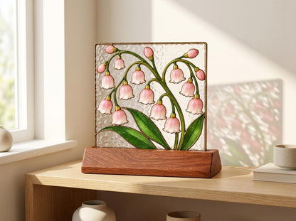 Pink Lily of the Valley glass tabletop glass decor near a bright window