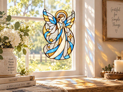 Blue gold and clear angel suncatcher displayed in a sunny home window